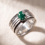 Brave Malachite sterling silver spinner ring on a bone linen ground