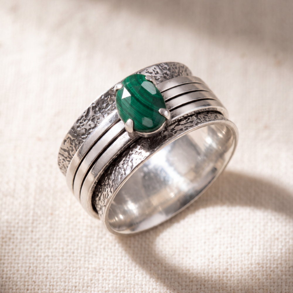 Brave Malachite sterling silver spinner ring on a bone linen ground