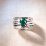 The Brave Malachite sterling silver spinner ring worn on the hand