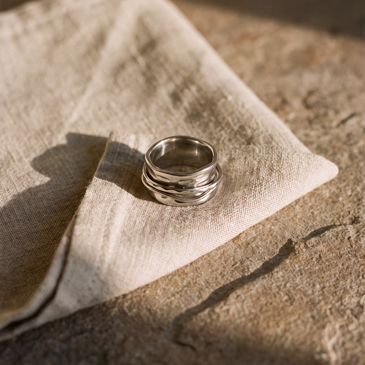 The Molten ring resting on natural linen