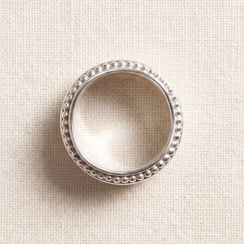 A woman's hand wearing the Resilience sterling silver spinner ring
