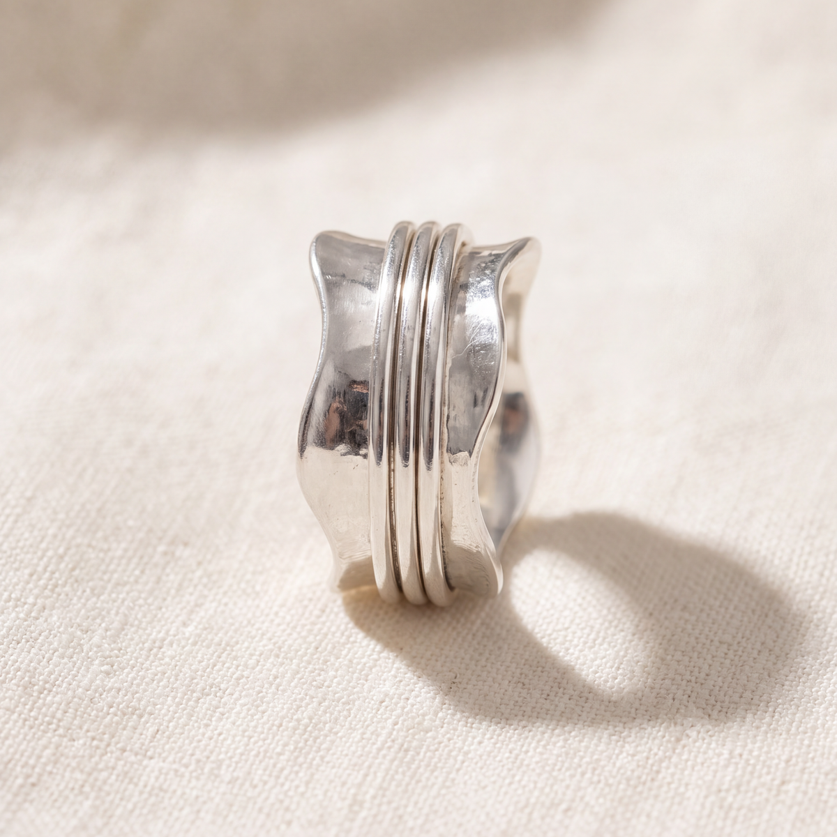 The Strength ring resting on natural linen
