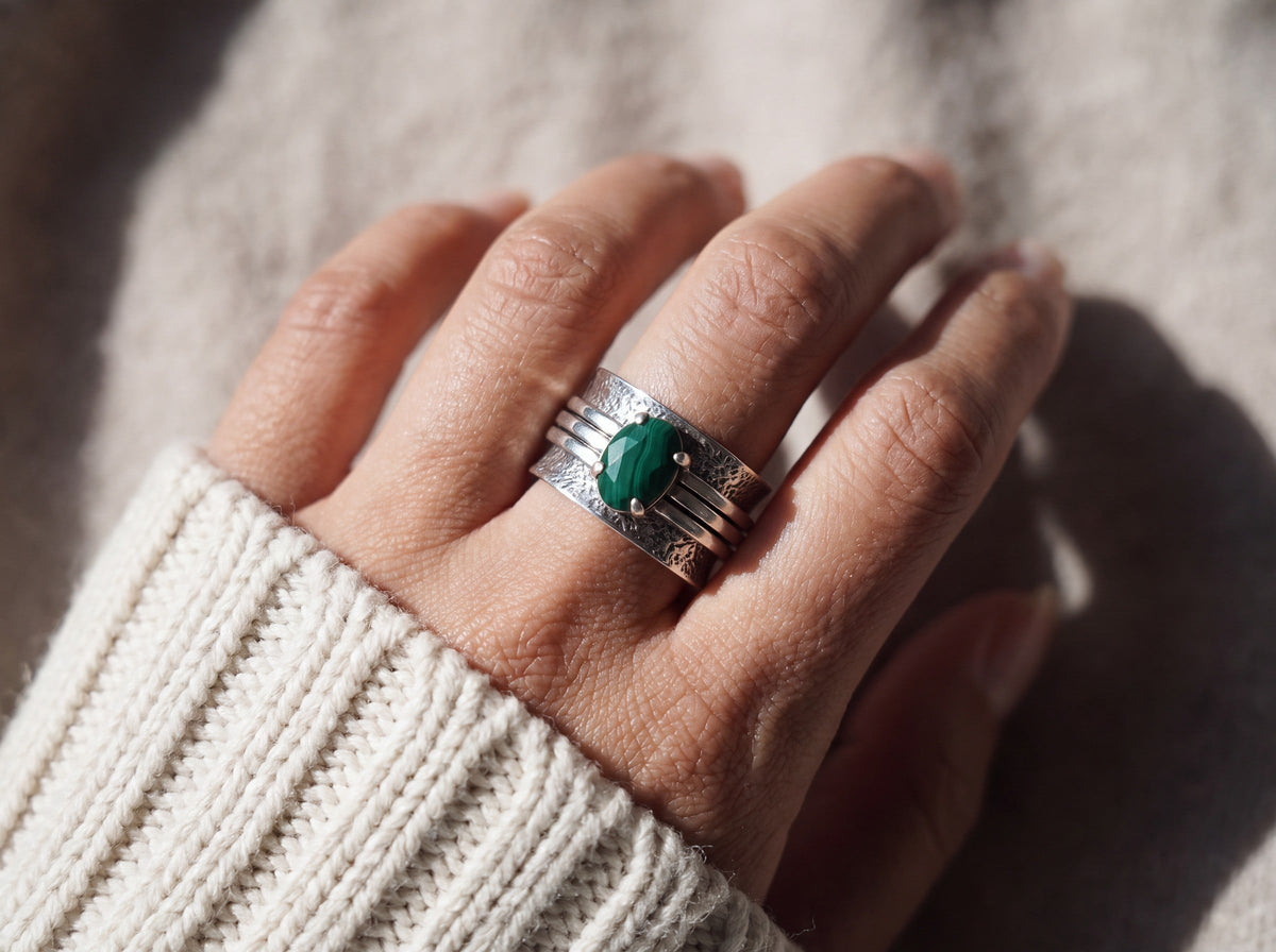 Close view of the faceted malachite in its claw setting