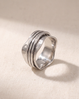 Wave 316L stainless steel spinner ring on a bone linen ground