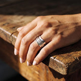 A woman's hand wearing the Wave 316L stainless steel spinner ring