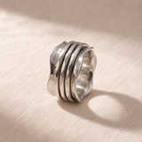 The Wave 316L stainless steel spinner ring worn on the hand
