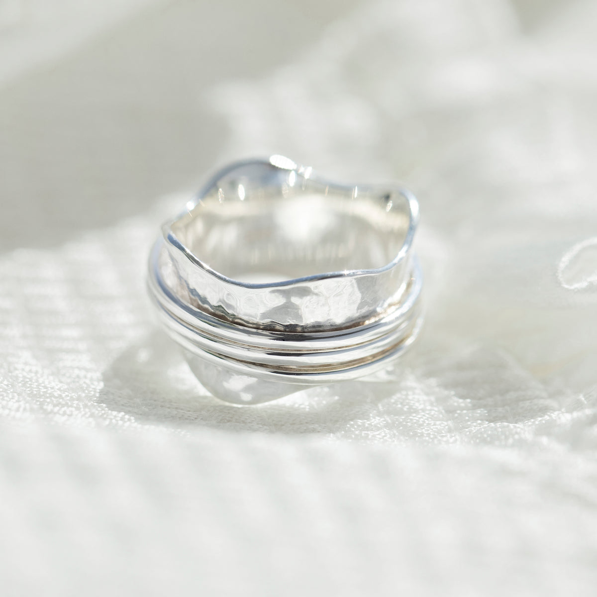 Close view of three plain bands turning on the Strength ring